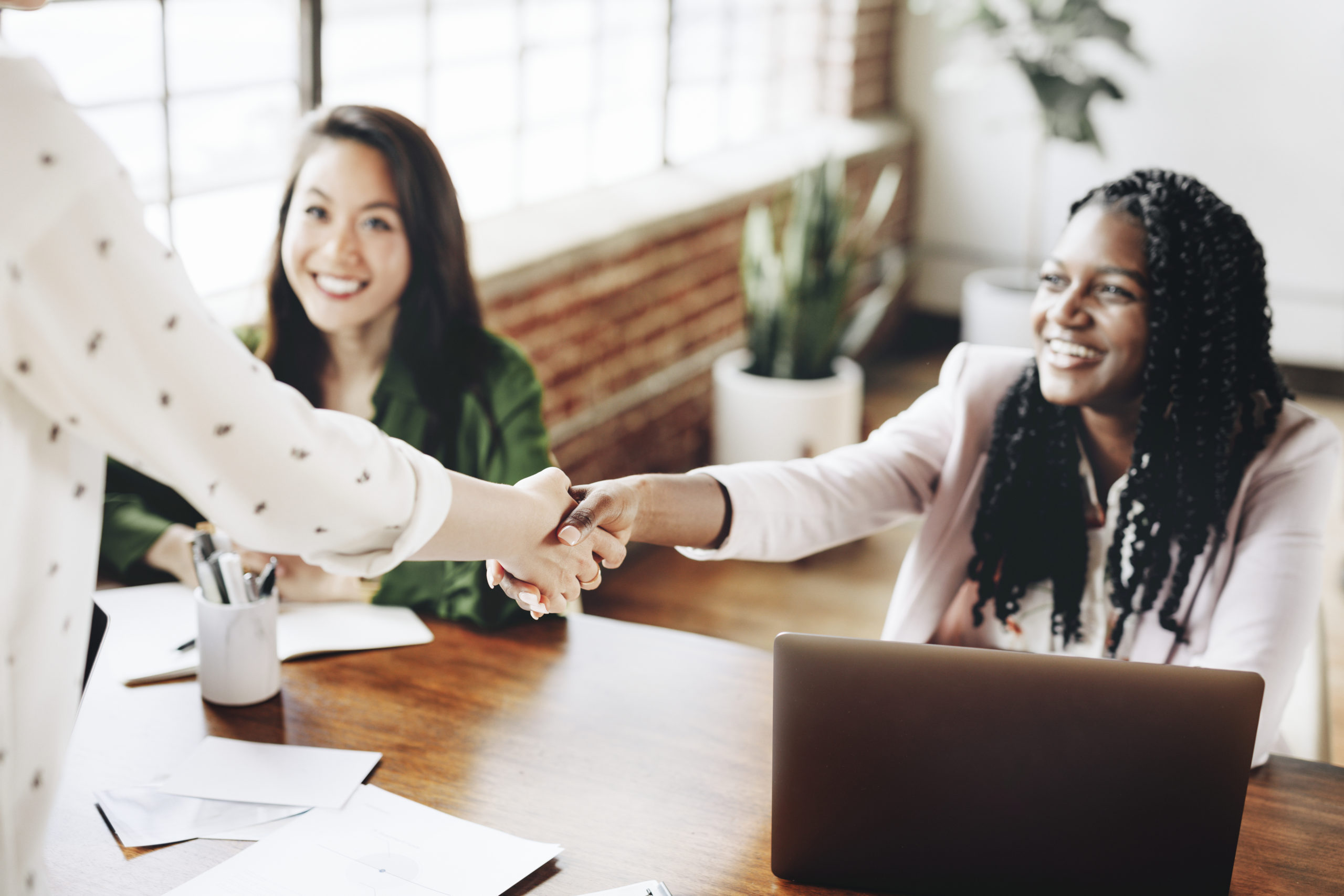 Happy businesswomen doing a handshake